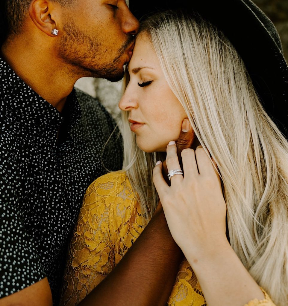 guy kissing girl's forehead at Garapata state beach California