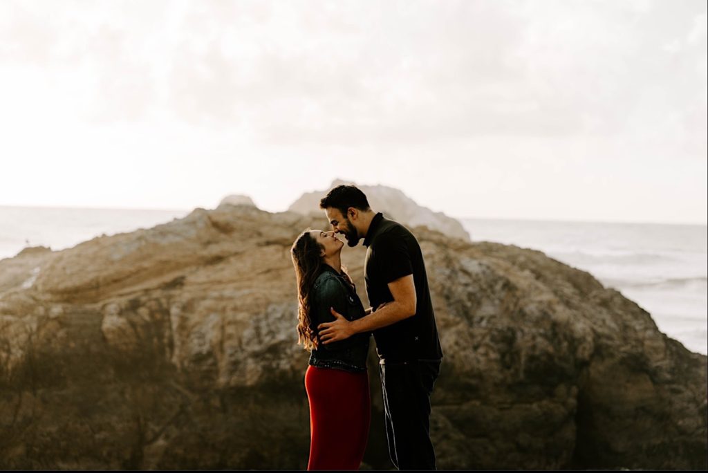 couple rubbing noses sutro baths san francisco