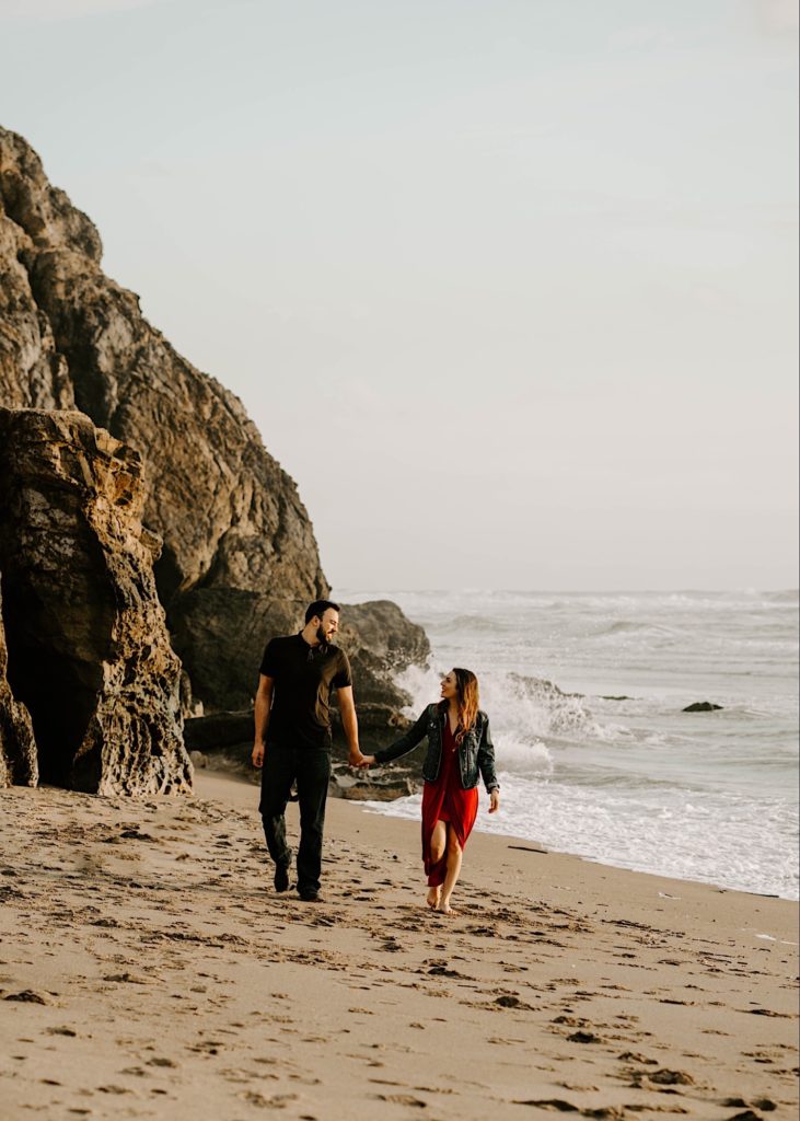 couple hold hands walking sutro baths san francisco