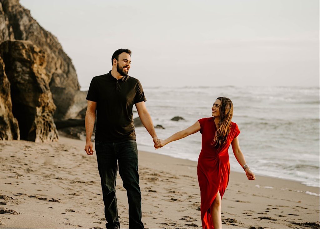 couple smiling at each other at sutro baths in san francisco