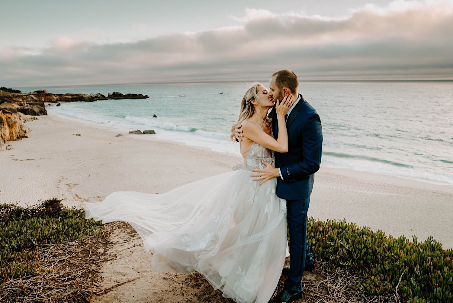 couple kissing at garapata state beach.