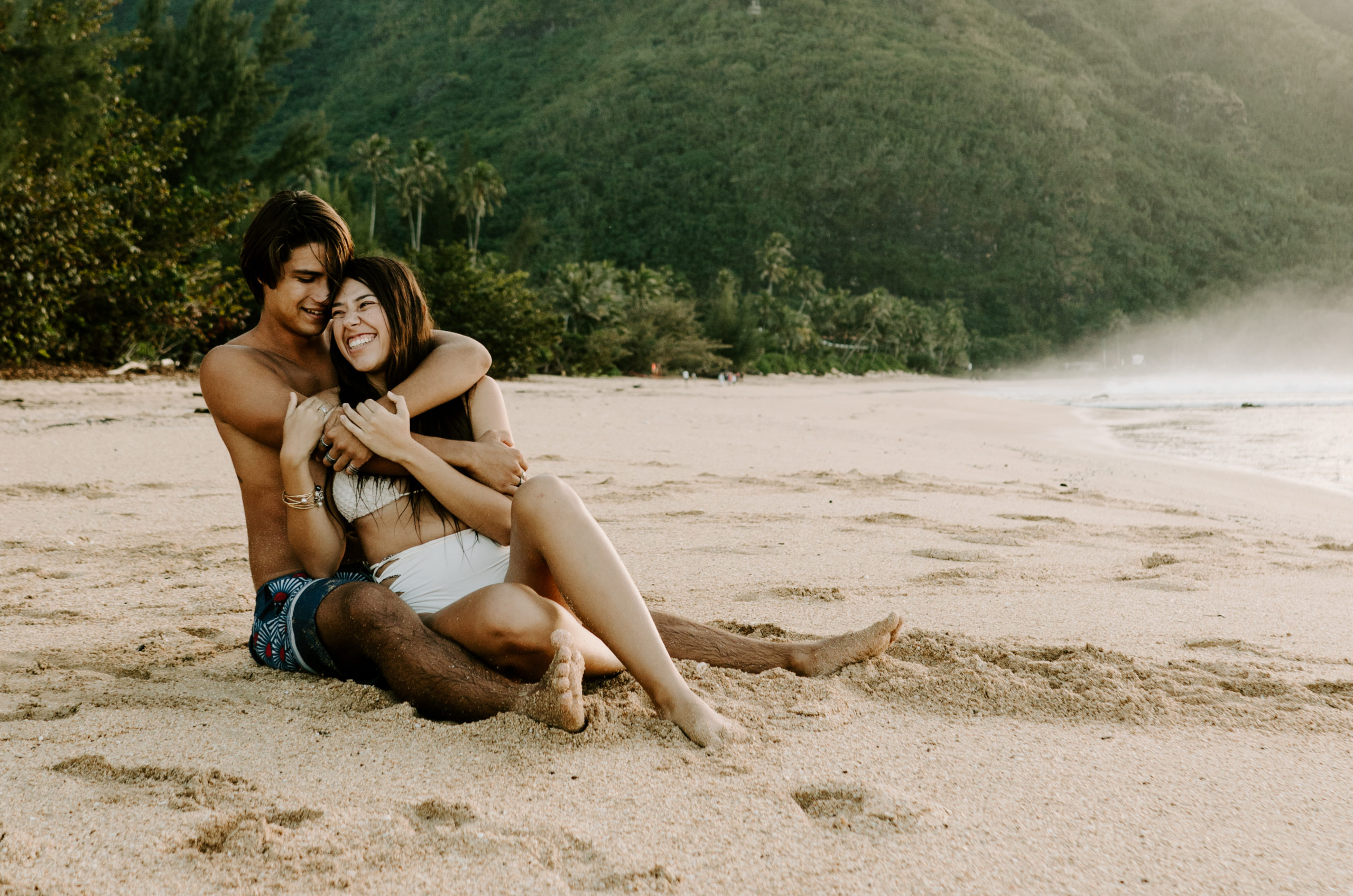hawaii beach couples session girl sitting in guys arms cuddling