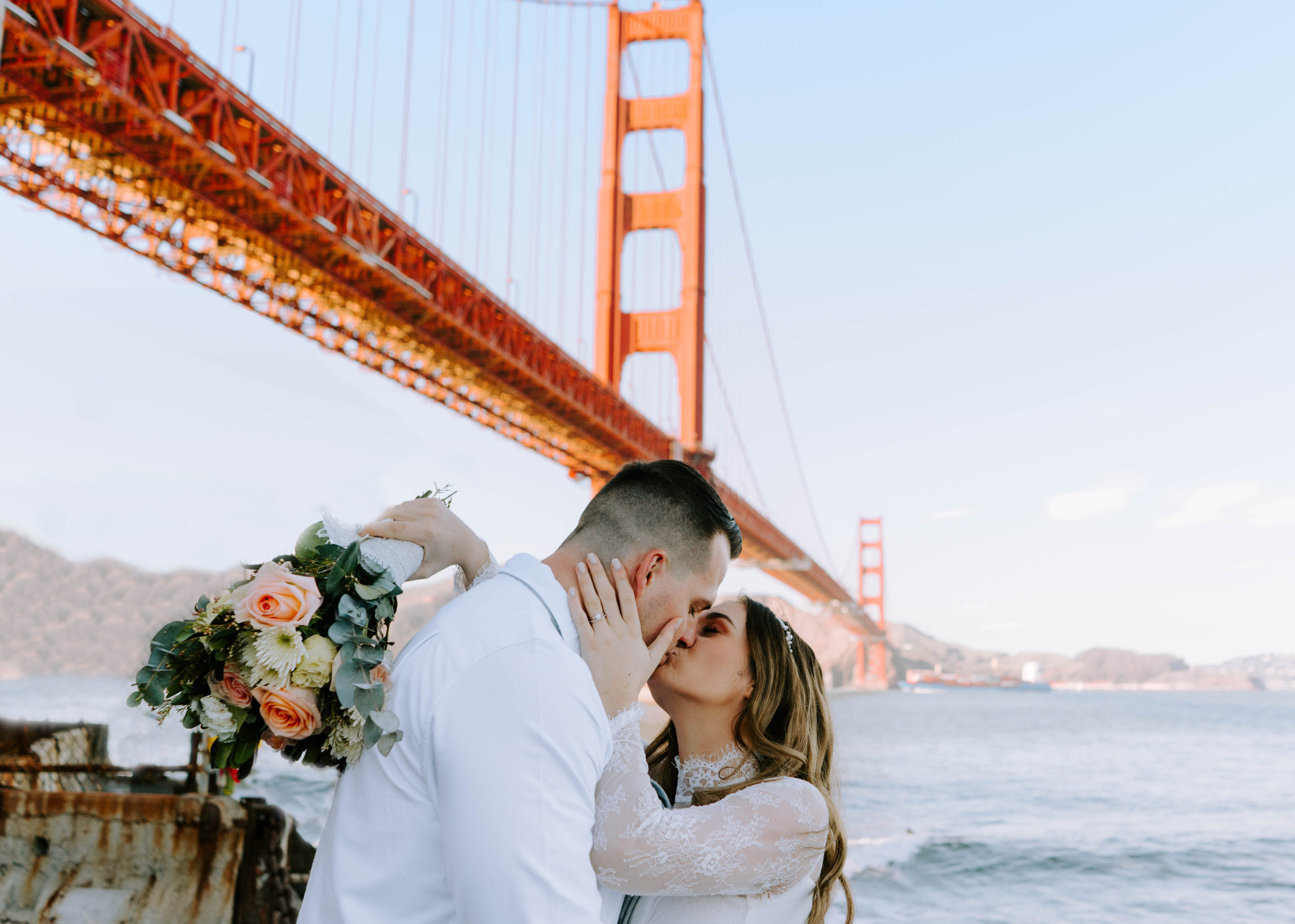 Newlywed couple kissing at the Golden Gate Bridge captured by San Francisco photogapher Torez Marguerite.