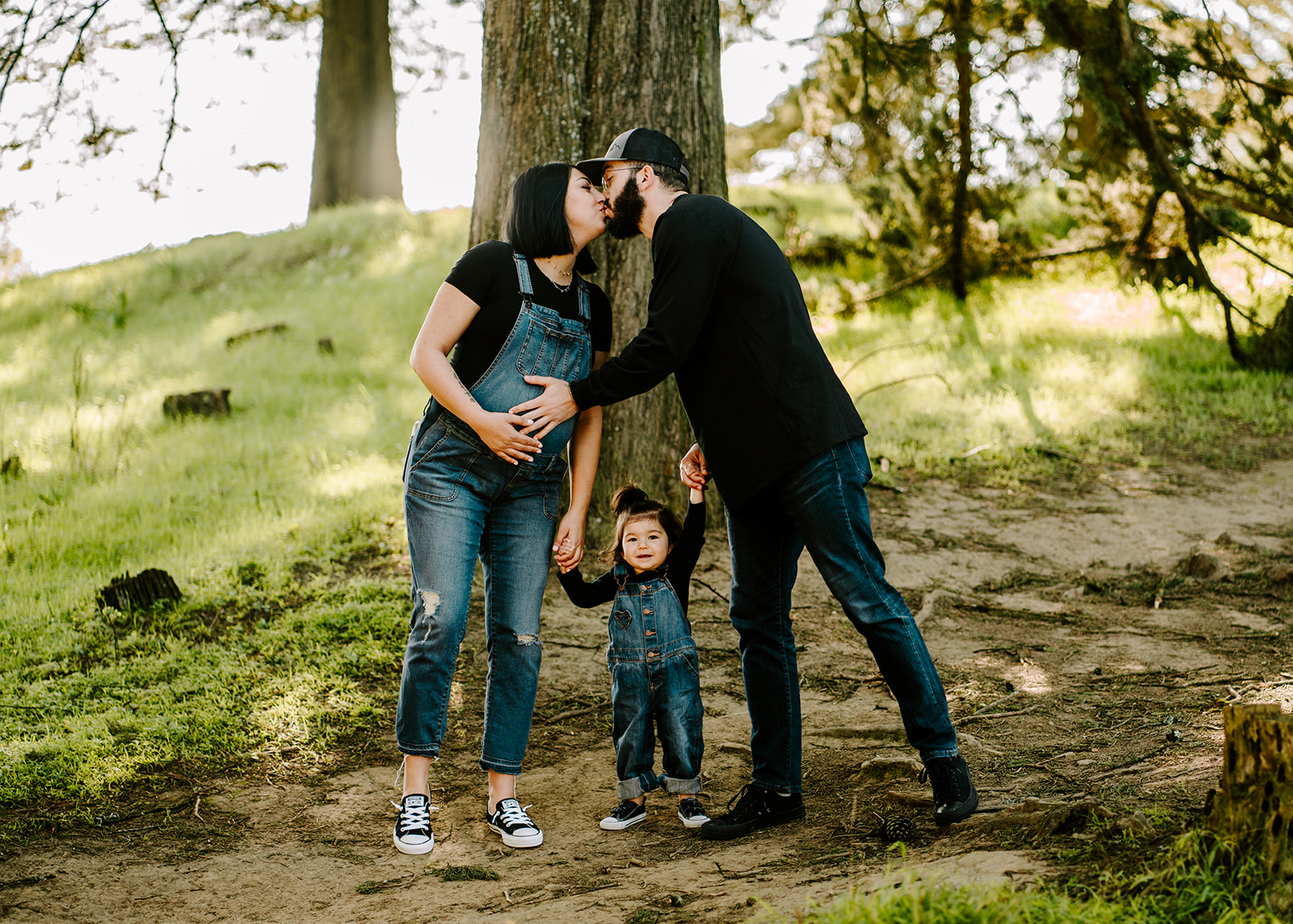 The Supples kissing during family photographer San Francisco maternity session.