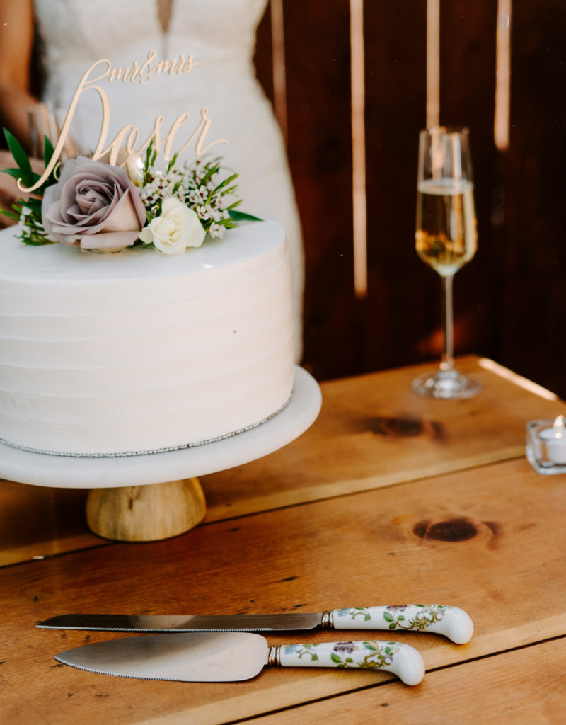 Wedding cake with champagne glass and cutting knives.