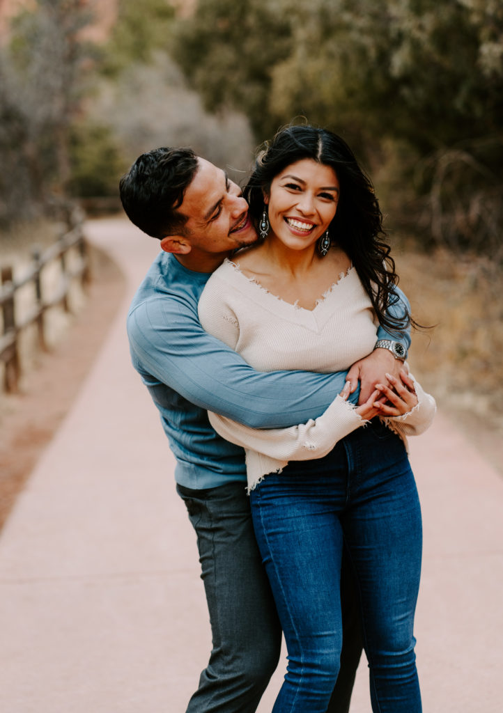 Man smiling and looking at woman while she smiles.