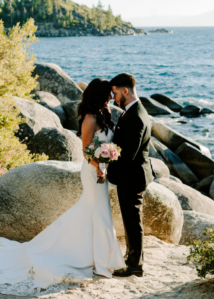 Bride and groom by the water at their Lake Tahoe wedding