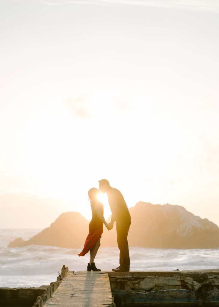 Woman and man kissing during sunset in San Francisco.