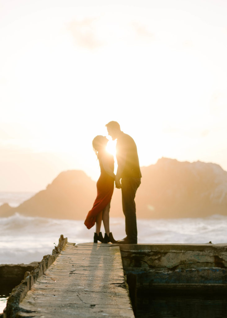 Woman and man almost kissing during sunset.