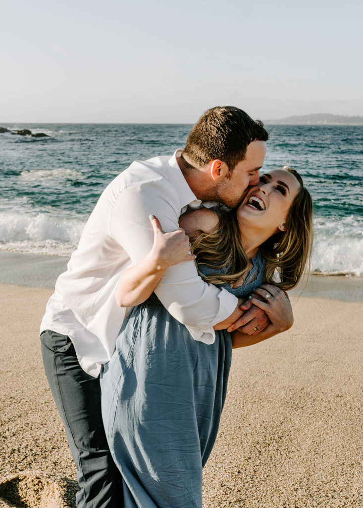 Big Sur engagement photo of couple hugging on beach