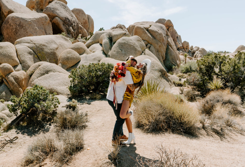Man and woman laughing together in Joshua Tree National Park.