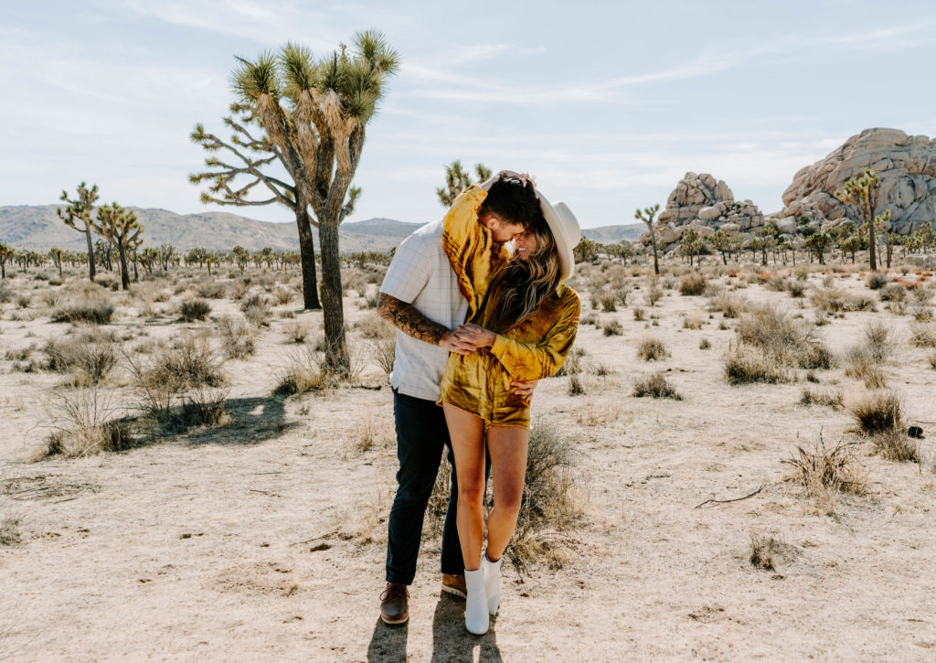 Woman and man kissing in Joshua Tree.