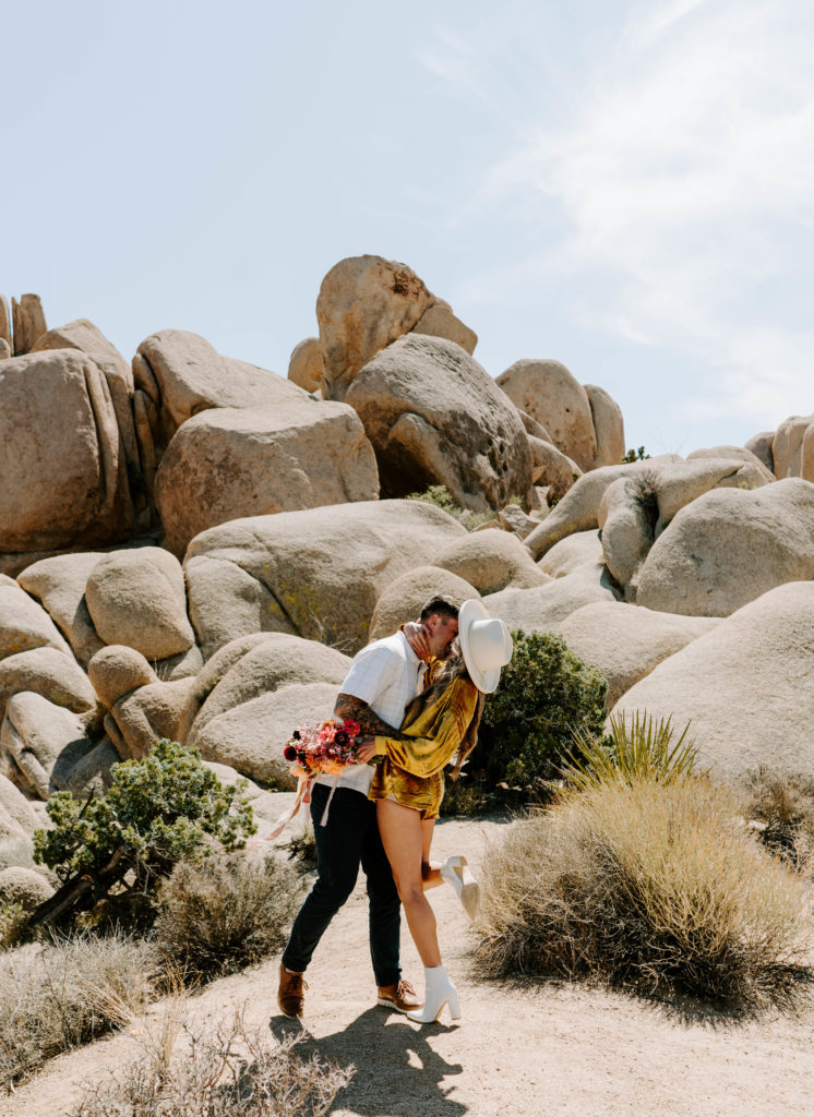 Man and woman kissing in Joshua Tree.