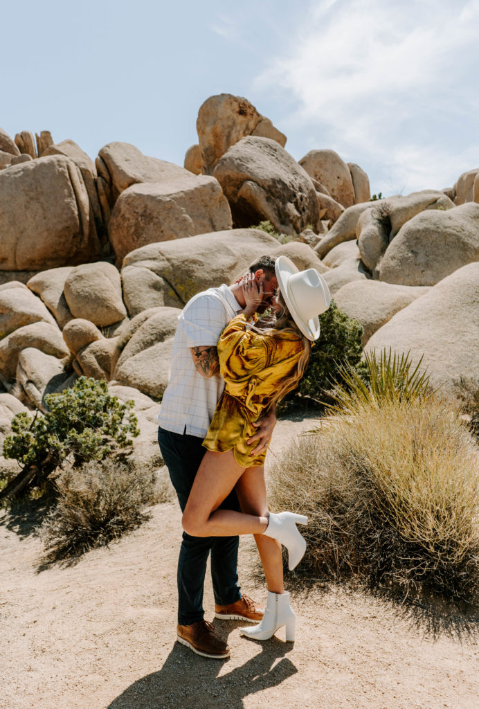 Woman and man kissing in Joshua Tree National Park.