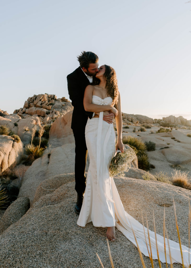 Bride and groom kissing in Joshua Tree National Park.