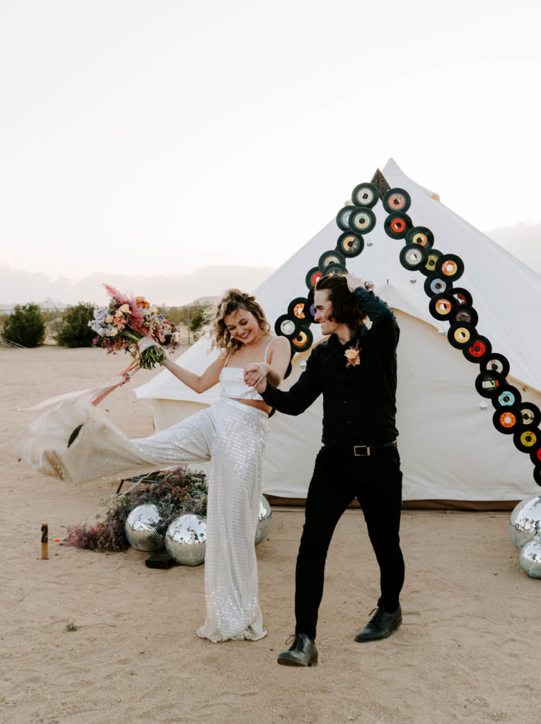 Bride and groom kicking up dust after their Palm Springs wedding.