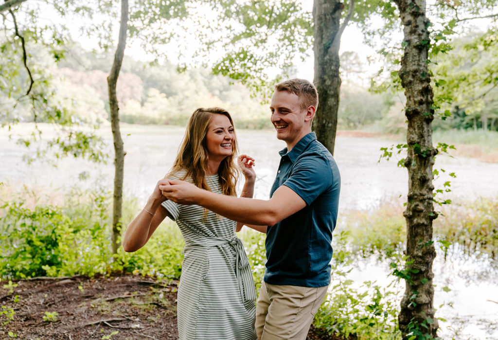 Couple dancing together near a marsh.