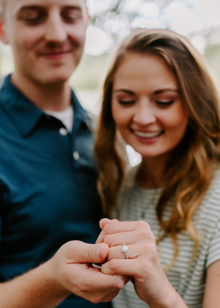 Couple showing engagement ring.