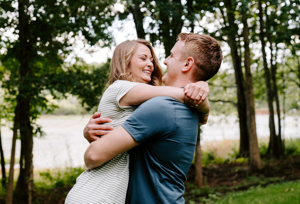 Couple smiling around near river bed.