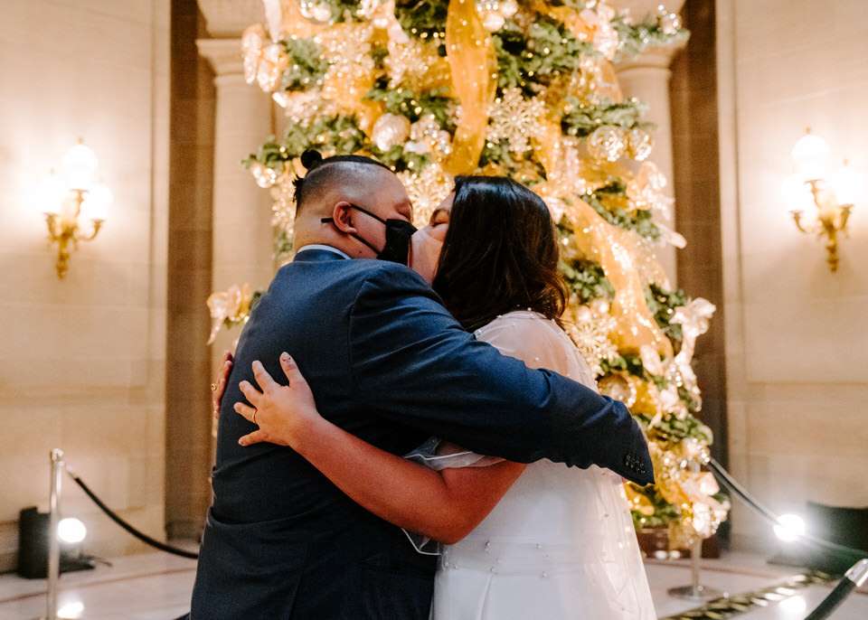 bride and groom kissing after getting married in San Francisco City Hall
