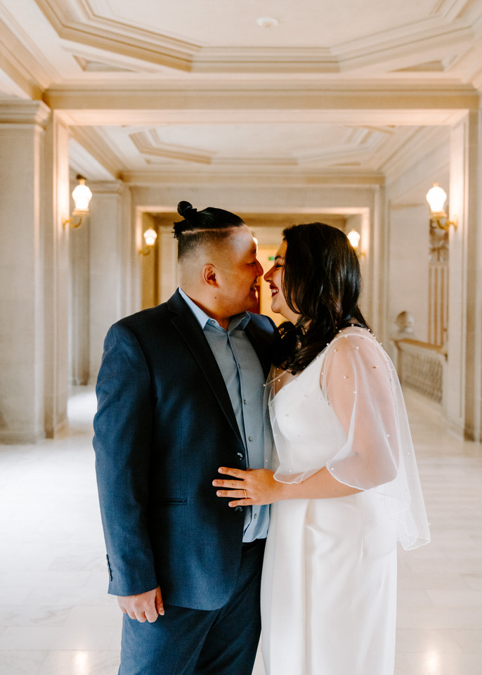 bride and groom smiling at each other during San Francisco City Hall wedding photographer