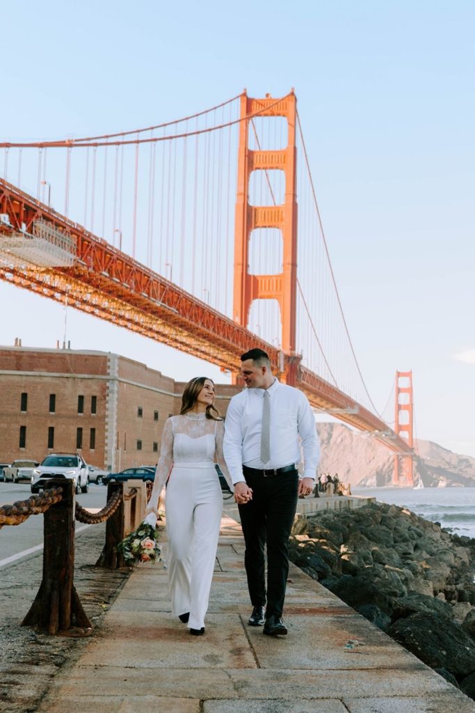 Couple walking away from Golden Gate Bridge