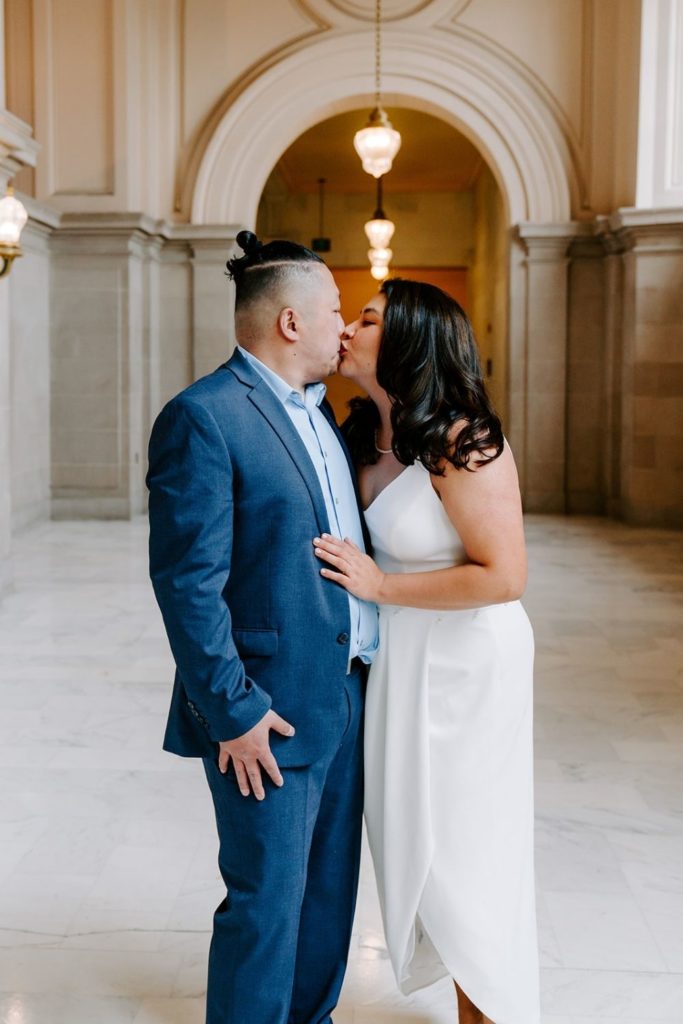 Couple kissing in San Francisco City Hall.