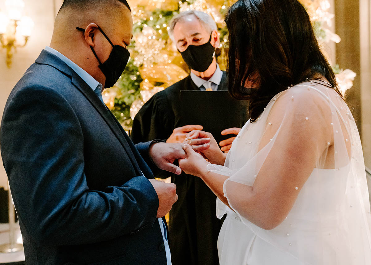 Couple exchanging rings during San Francisco City Hall wedding