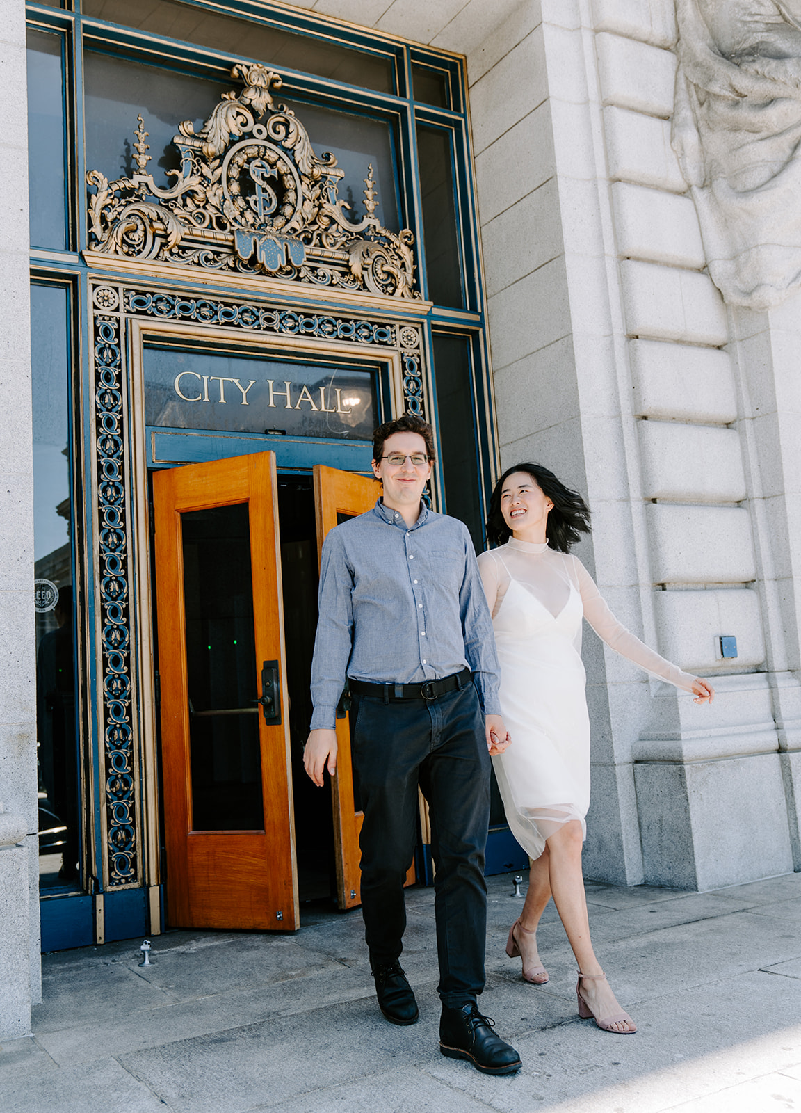 Couple walking out of San Francisco City Hall after eloping.