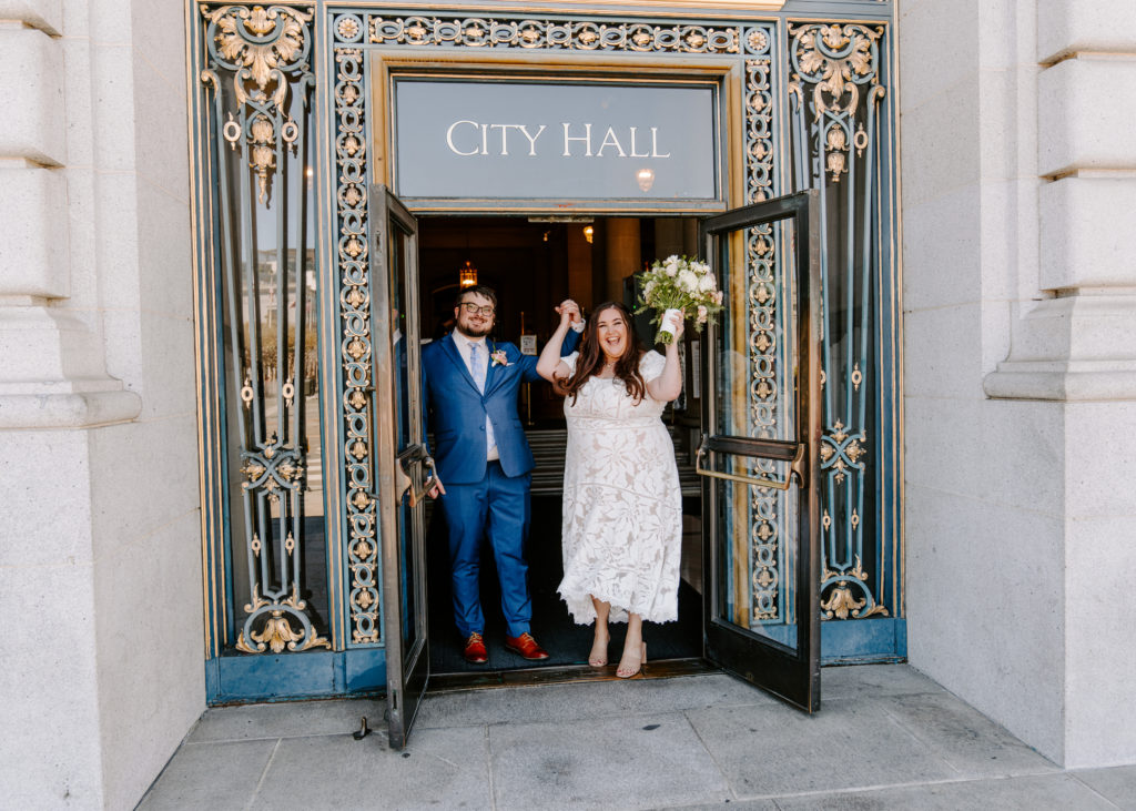 Couple celebrating getting married in San Francisco City Hall.