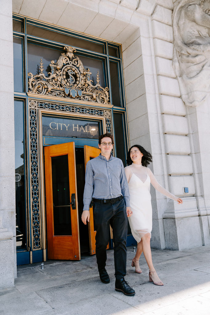 Couple walking out of San Francisco City Hall.
