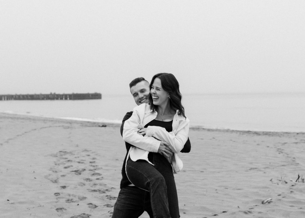 Couple laughing on the beach in SF.
