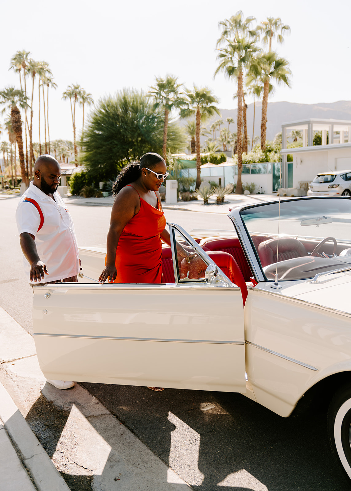 woman getting into classic car