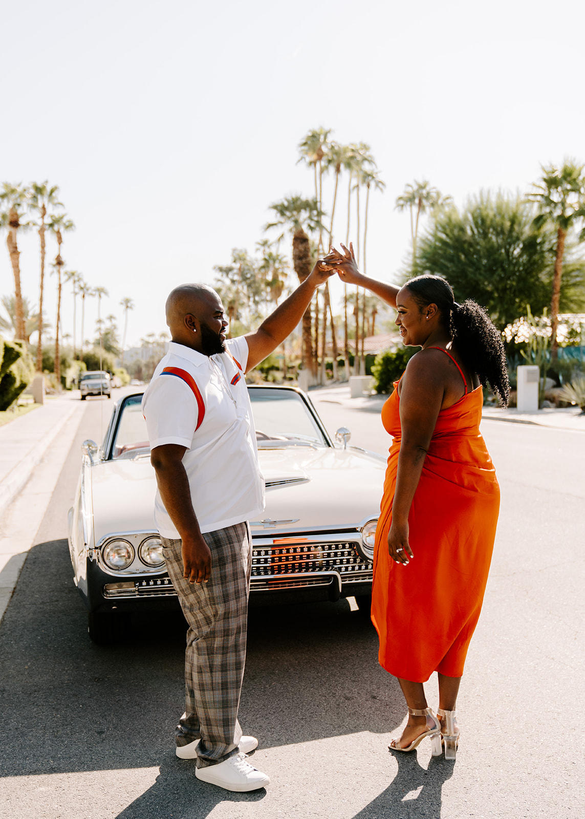 couple dancing in front of classic car in california