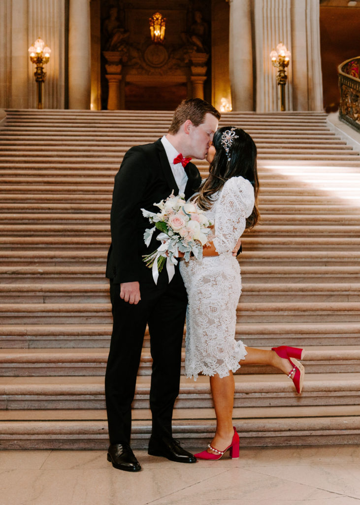 couple at the bottom of grand staircase in SF City Hall