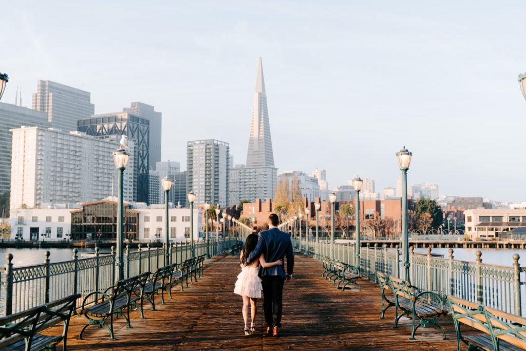 couple walking along pier 7 in SF.
