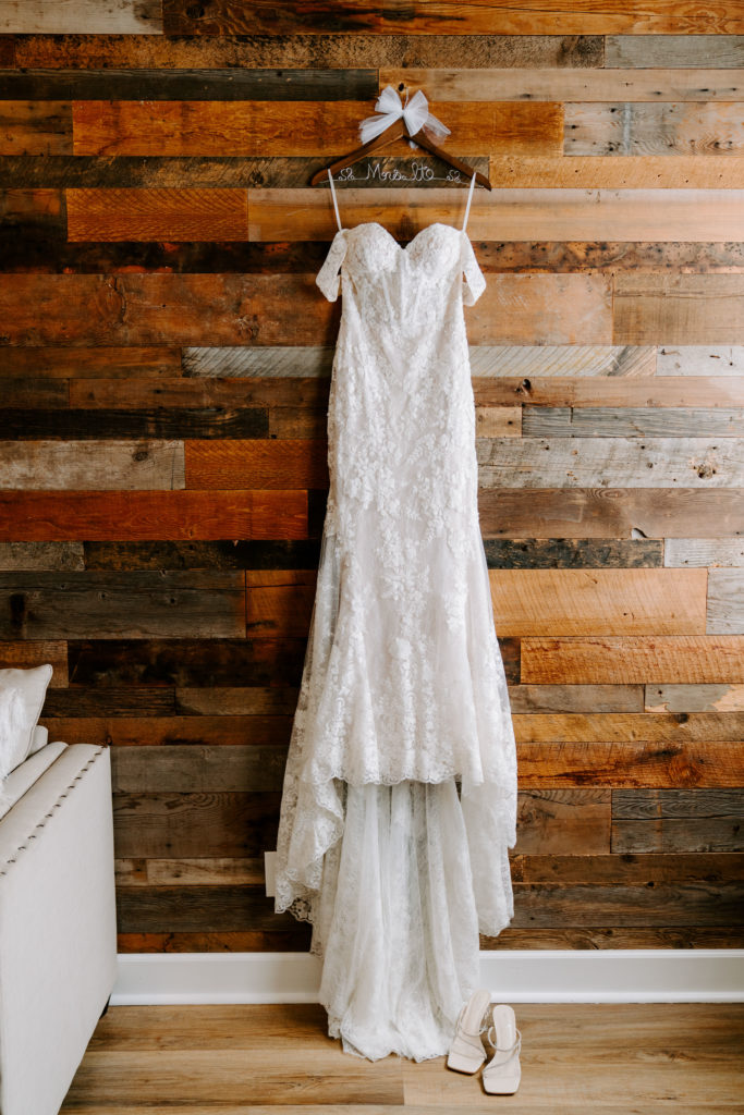 bride's dress hanging with shoes