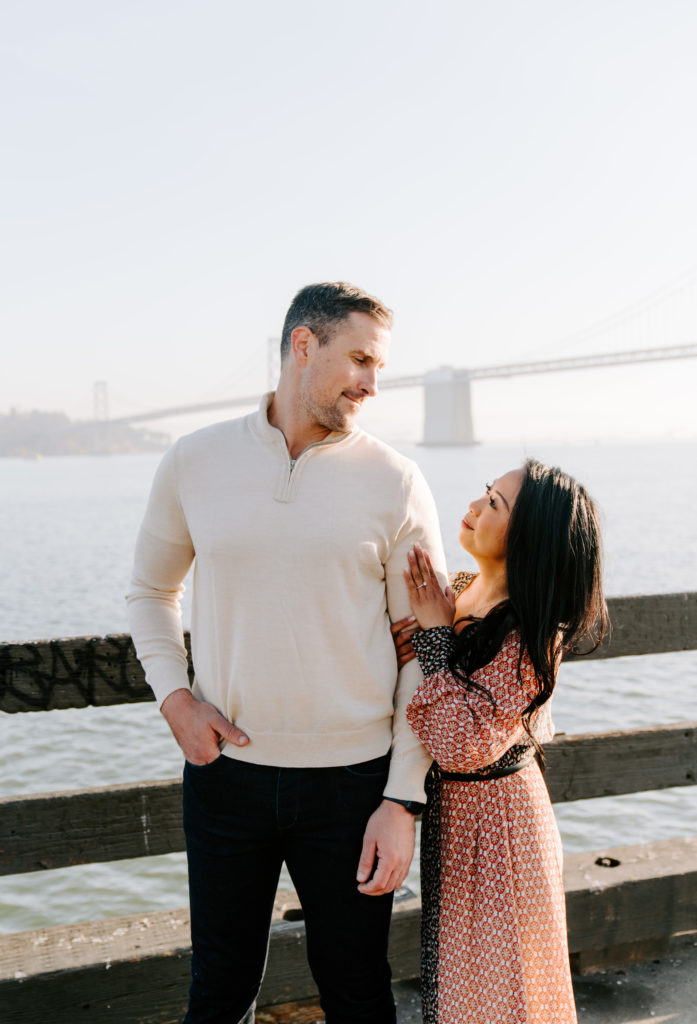 Couple in front of the Bay Bridge.