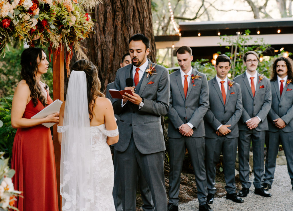 groom reading vows during ceremony