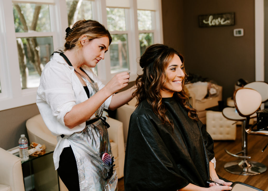 hairstylist finishing bride's hair
