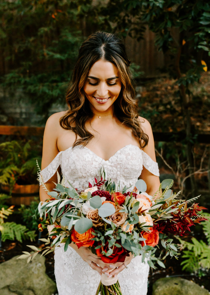 bride looking at bouquet