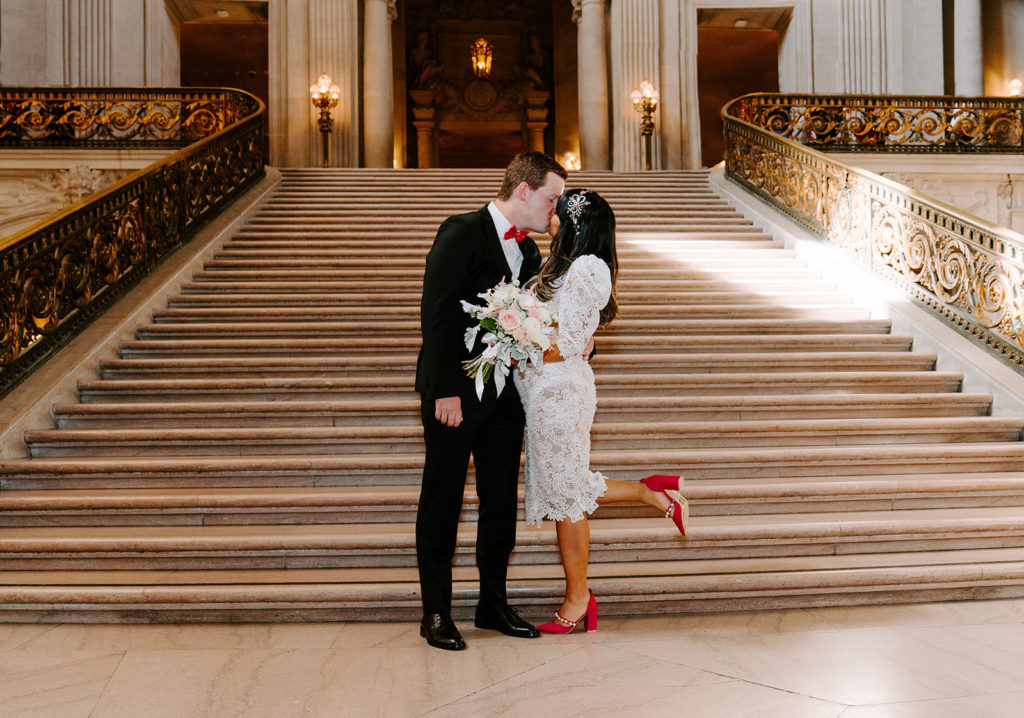bride and groom kissing sf city hall