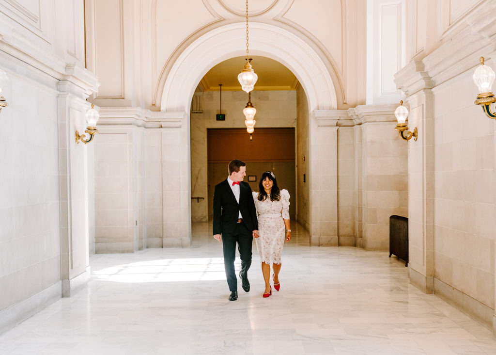 bride and groom walking 4th floor sf city hall