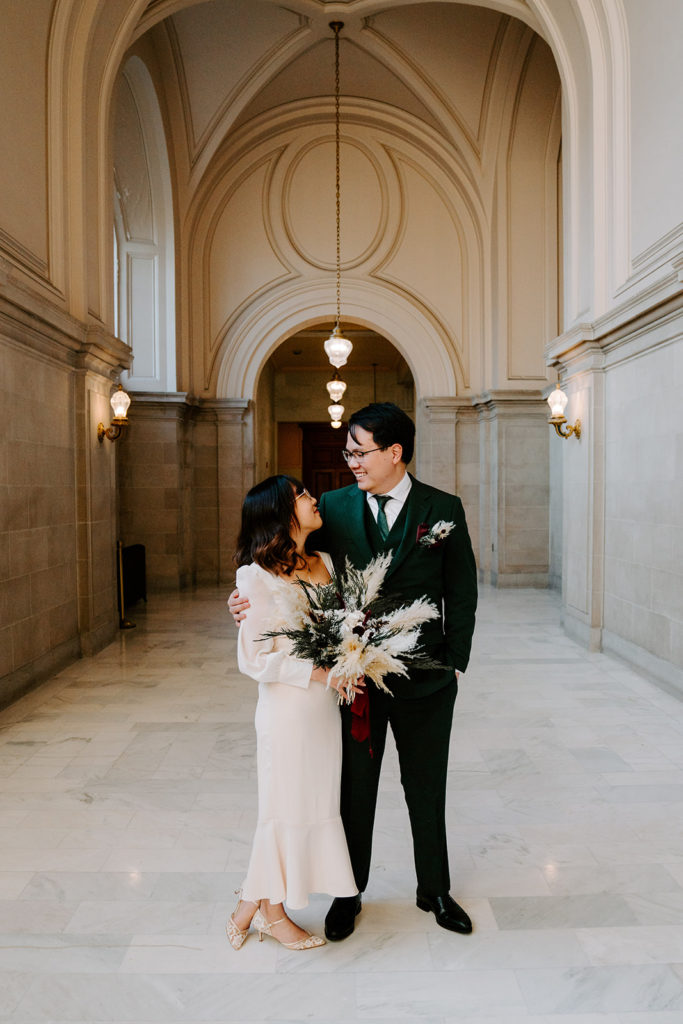 couple looking at each other during christmas engagement photos