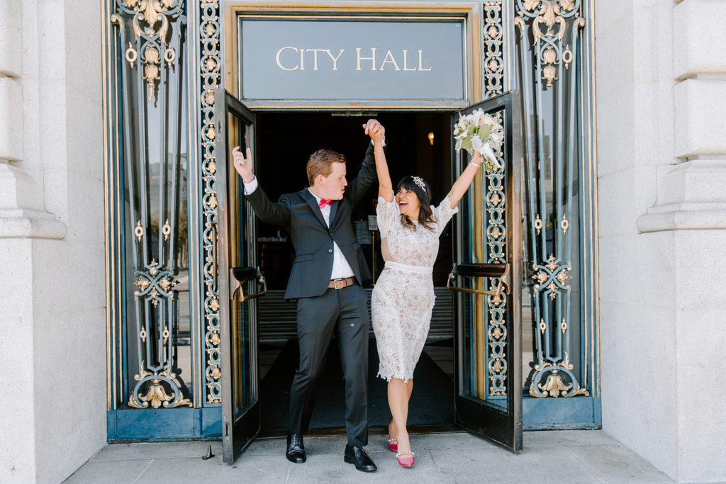 couple walking out of san francisco hall after wedding