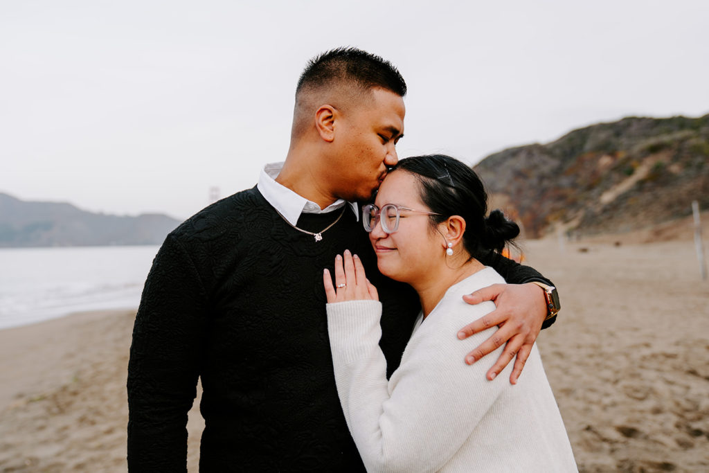 couple snuggling on the beach