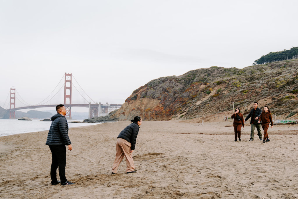 family surprising girl at beach